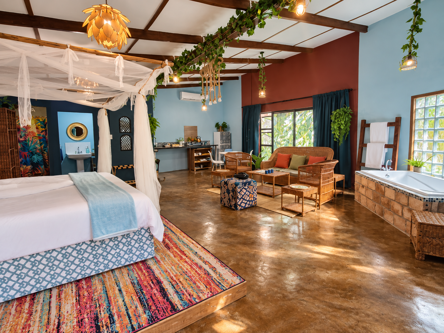 Wide interior view of the Superior Deluxe Two Sleeper with king-size bed, lounge, soaking bath and kitchenette at Gala-Gala Eco Resort